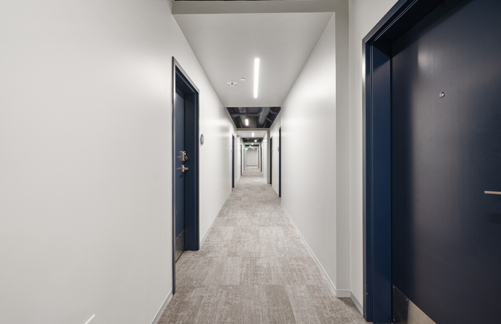 Interior hallway with navy blue doors in Exterior view of Urbane 1220 mixed use development in downtown Sioux City
